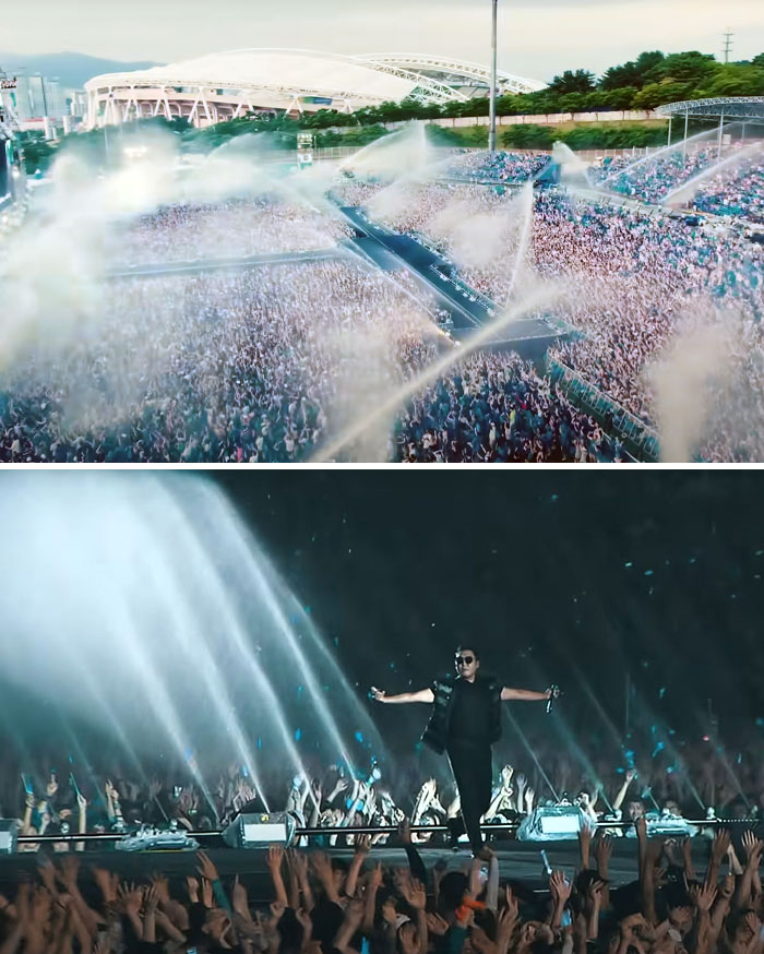 Crowd at a concert being sprayed with water jets as an example of celebrity wastefulness.