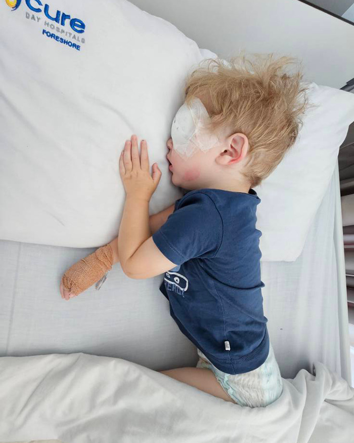 Toddler in hospital bed with eye bandage, at risk from herpes virus. Toddler in hospital bed with eye bandage, at risk from herpes virus.