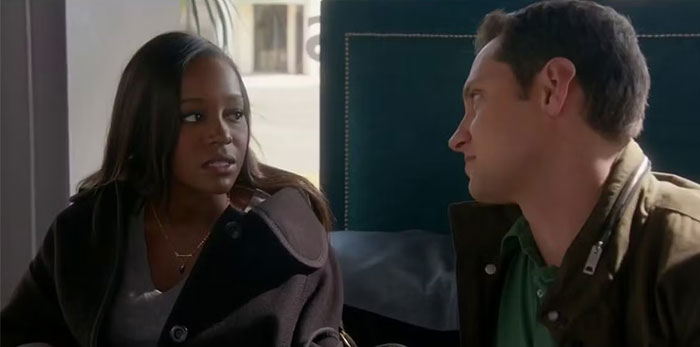 Two TV characters sitting and looking at each other, showcasing minimal chemistry.