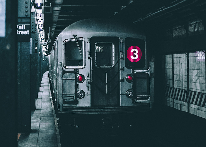Subway train with number 3 sign at Wall Street station, evoking unsettling facts shared by influencers.