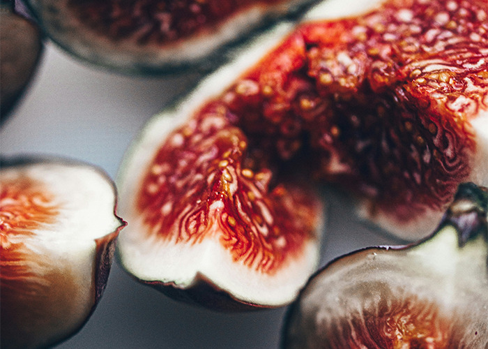 Close-up of a sliced fig showing intricate red and white textures, highlighting unusual and unsettling details.
