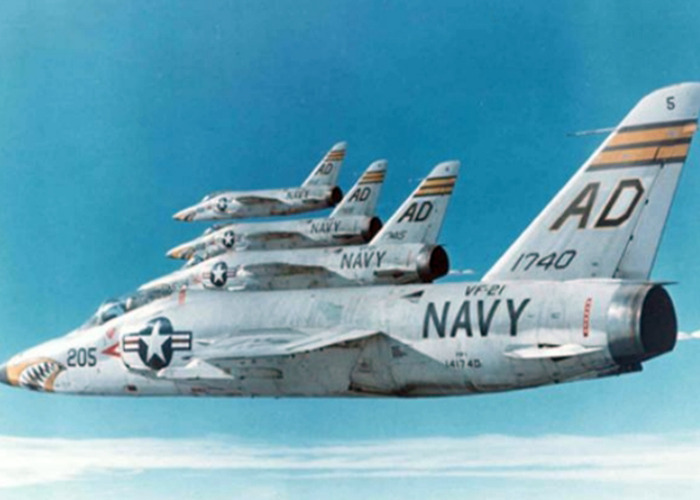 Navy jets flying in formation against a clear sky, showcasing unusual aviation precision.