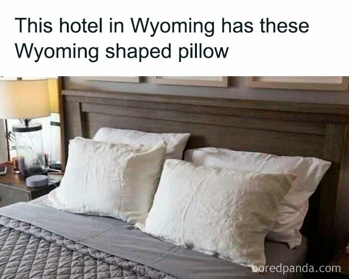 Wyoming hotel bed with Wyoming-shaped pillow, humorously highlighting random memes.