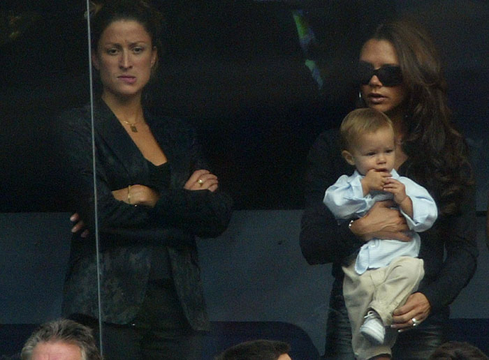 Woman in black outfit beside another holding a child, related to Beckham ex-assistant interview affair buzz.