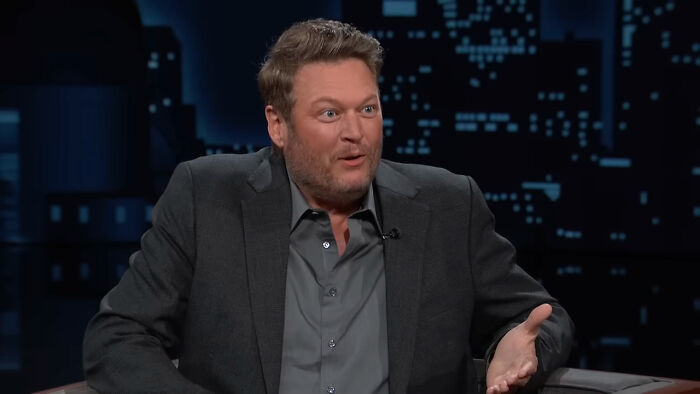 A celebrity in a talk show setting, wearing a dark suit, part of a segment discussing petty reasons for public dislike.