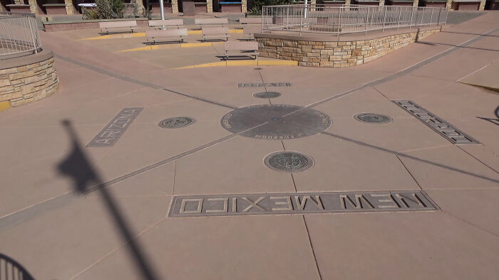 Four Corners Monument, known touristy place, featuring state boundaries of Arizona, Colorado, Utah, and New Mexico.