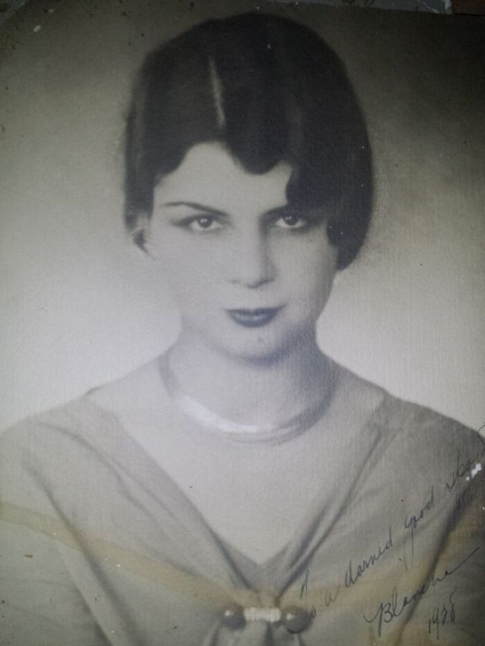 Vintage portrait of a woman from 1928 wearing a necklace, showcasing how much the world has changed over 100 years.