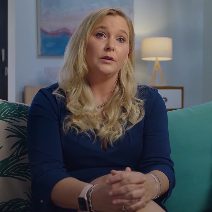 Woman sitting on a couch, discussing a suspicious incident involving Prince Andrew's accuser in an interview setting.