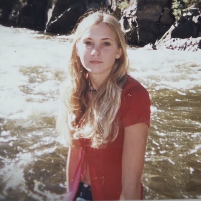 Young woman with long hair in front of a river, related to Prince Andrew's accuser.