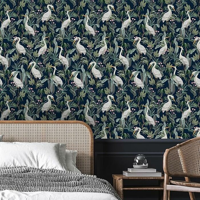 Bedroom with patterned wallpaper showcasing herons and foliage, highlighting easy-to-learn life skills in decor.