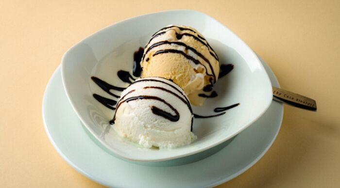 Ice cream scoops with chocolate drizzle in a bowl, representing weird food combos.