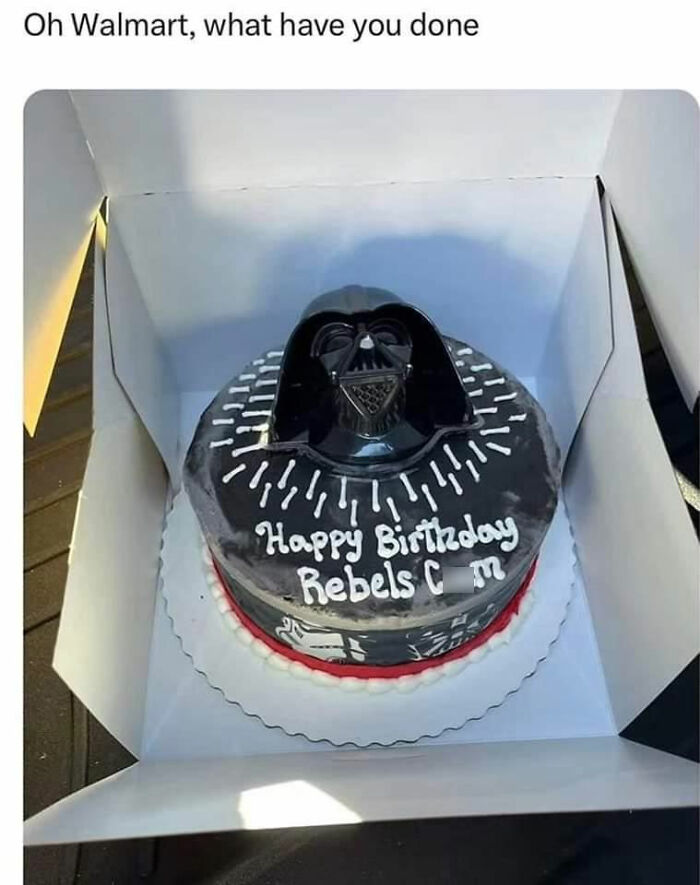 Darth Vader cake with "Happy Birthday Rebels C*m" misspelled, inside a box, creating an amusingly awkward moment.