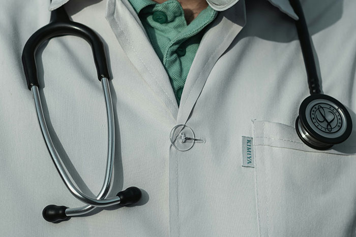 Close-up of a doctor's lab coat with a stethoscope, highlighting what can be considered normal in the USA.