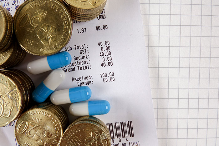 Coins and pills on a receipt, highlighting things only normal in the USA.