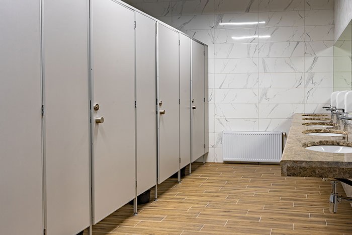 Public restroom with stalls and sinks, highlighting common American feature.