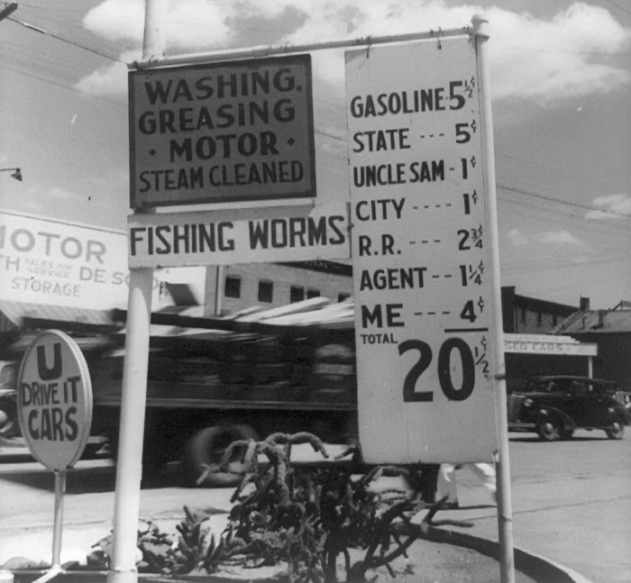 Vintage gas station sign showing 1940s prices, showcasing everyday American life in the past.