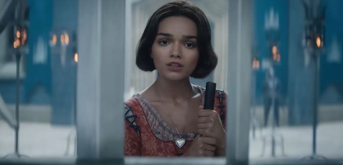 Young woman holding a broom in a castle, from the Snow White live-action film criticized by Disney shills.