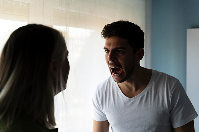 Man arguing with a woman, expressing the loss of trust and grief over their dog's sudden absence.