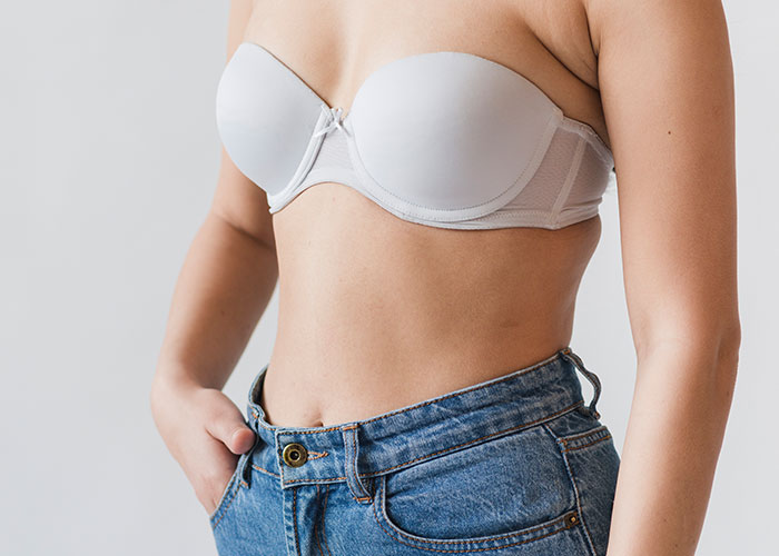 Person in a white strapless top and jeans, hand in pocket, representing wild audition stories.