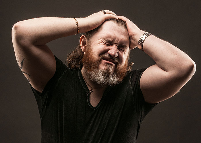 Man holding head in frustration, embodying wild audition story emotion.