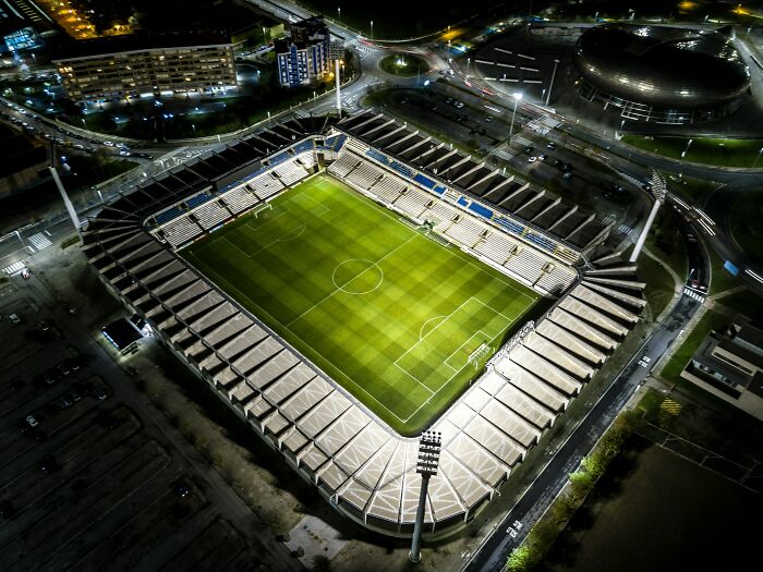 Aerial night view of a brightly lit soccer stadium, one of the iconic cathedrals of soccer where legends are born.