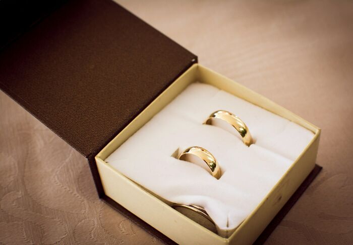 Golden rings in a brown box, symbolizing secrets people keep from their families.