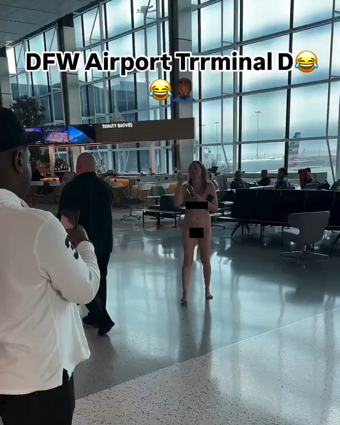 Person having a meltdown in airport terminal, people observing in the background.
