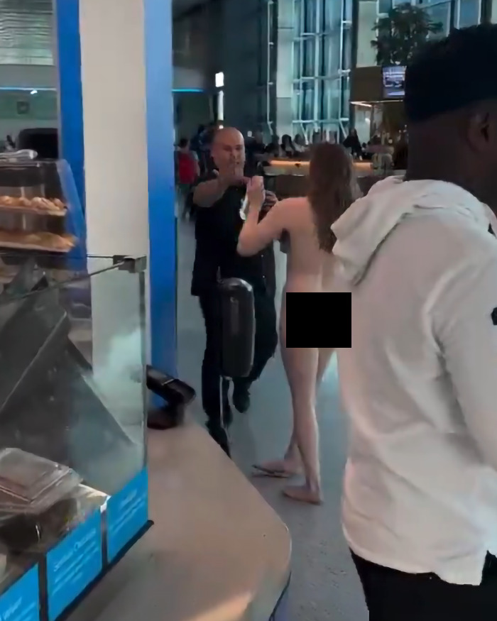 A woman having a meltdown is filmed running nude through an airport.