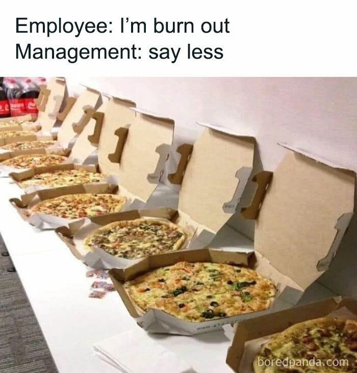 Open pizza boxes lined up on a table with a humorous work meme about burnout.
