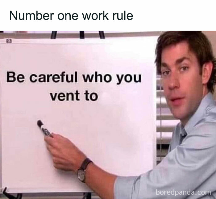 Man pointing at a board with text "Be careful who you vent to" in a work meme, adding humor to workplace stress.