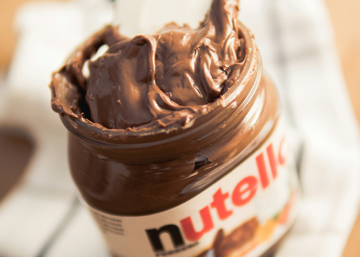 Jar of Nutella with lid off, representing a possible worst diet shared by people.