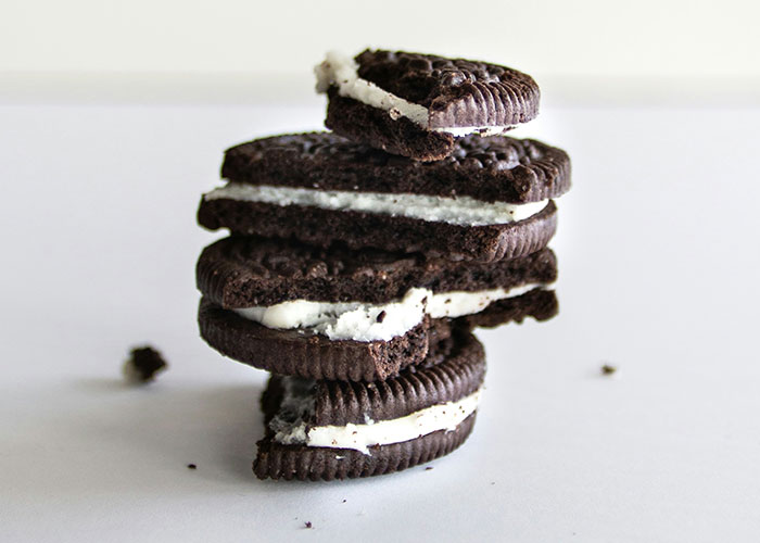 Stack of chocolate sandwich cookies with cream filling, highlighting unhealthy diet choices.