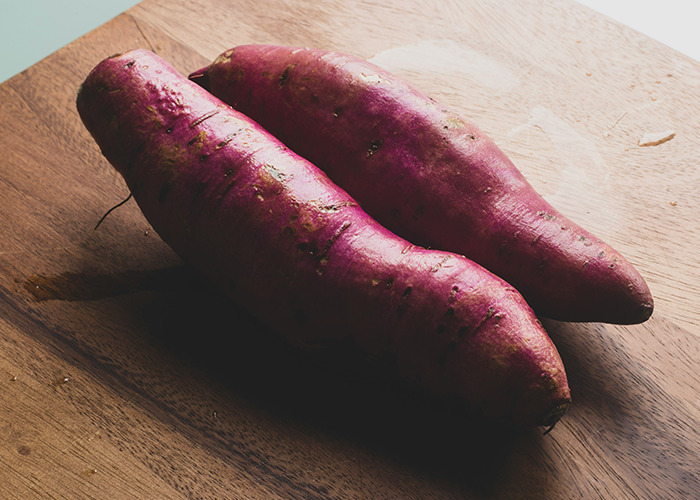 Two sweet potatoes on a cutting board, related to worst diets topic.