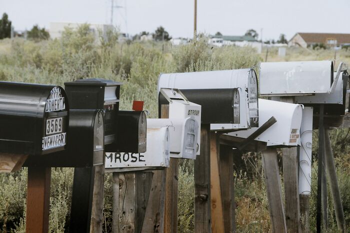 Row of vintage mailboxes on rural roads, symbolizing historical turning points in communication.