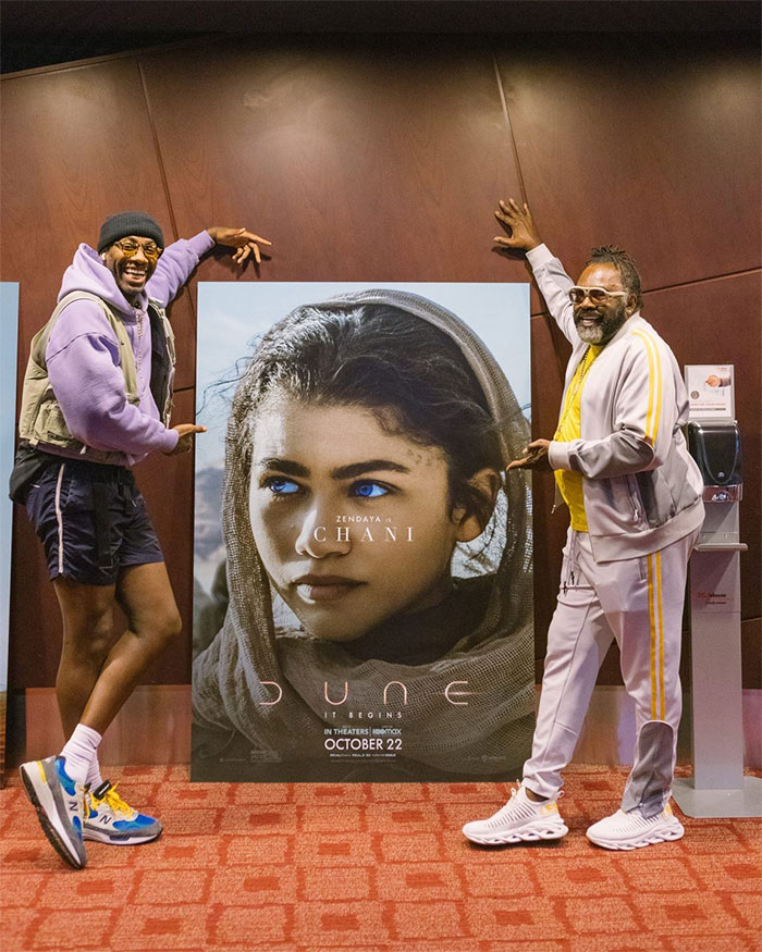 Two men, including Zendaya's father, posing with a movie poster of Zendaya as Chani, highlighting Zendaya&rsquo;s family connection.
