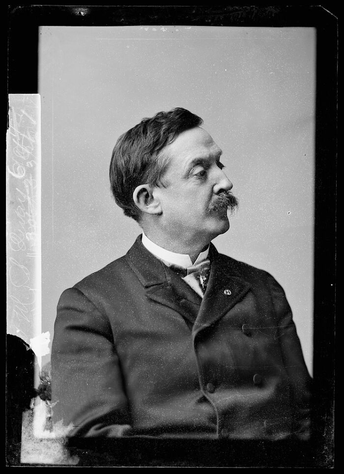 Black and white vintage portrait of a man in a suit, showcasing rare photographs rescued from glass negatives.
