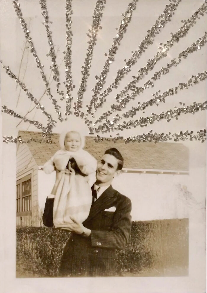 A joyful man in a suit holding a bundled baby, with decorative rays in the background, illustrating a love without boundaries.