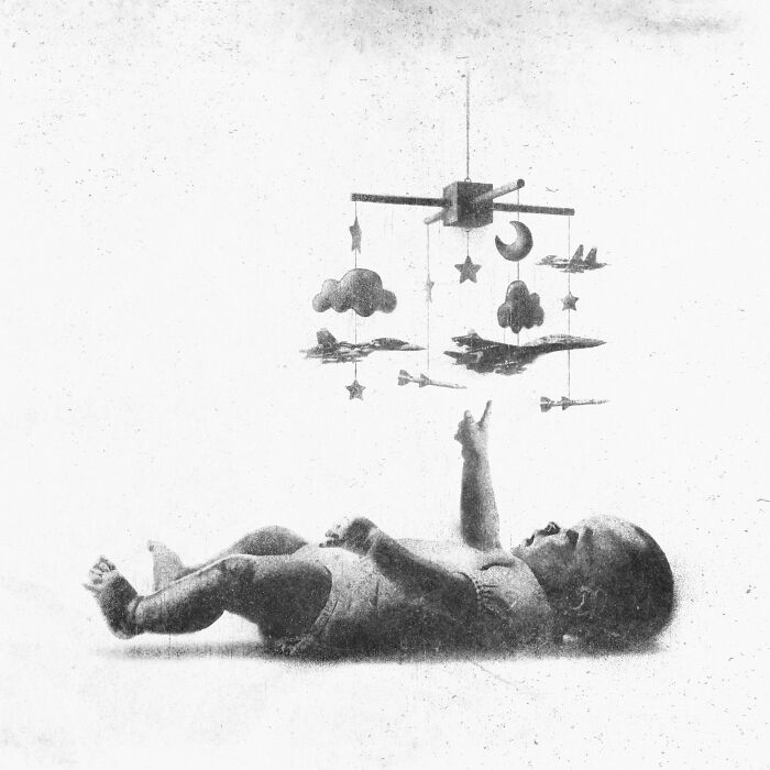 Baby reaching for a mobile with planes and clouds, symbolizing the madness of our times in modern art.