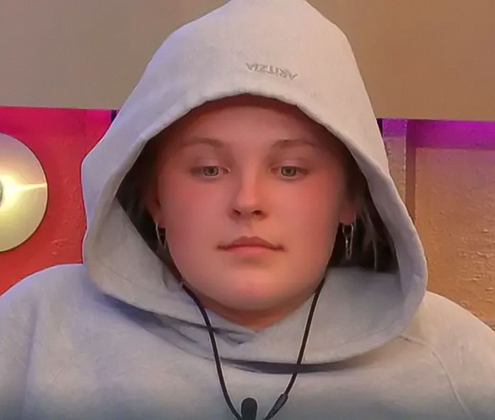 Person in a hoodie on Big Brother show, related to JoJo Siwa's recent moment.