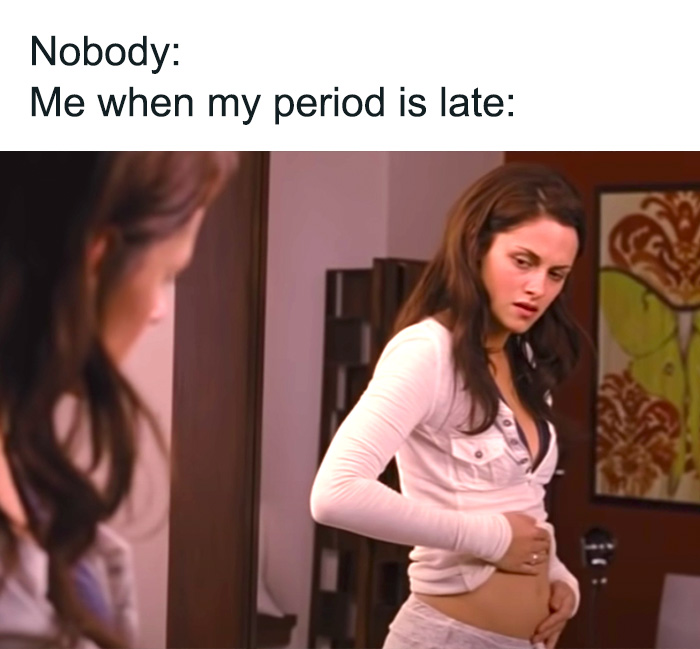 Woman in white shirt concerned, checking herself in the mirror, relates to period meme humor.