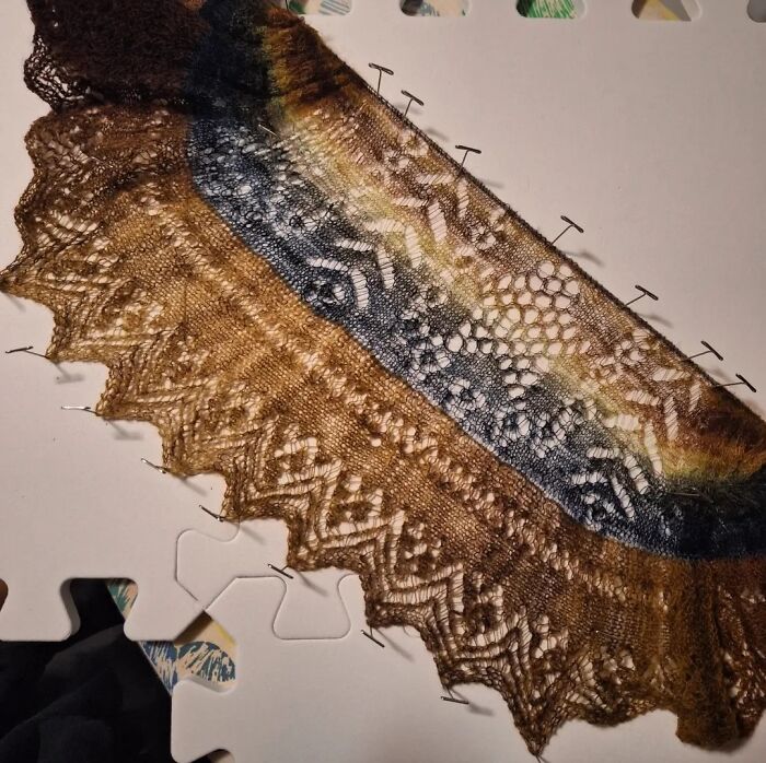 Intricate lace knitting with earthy tones on display, highlighting craftsmanship skills.