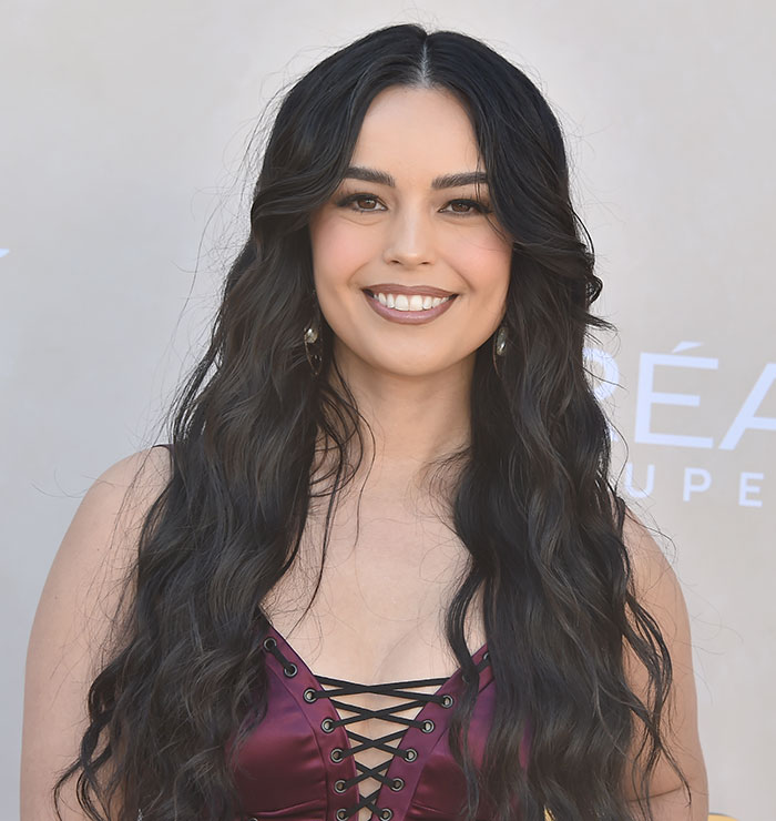 Streamer with long dark hair smiling, connected to 'Minecraft' scene controversy.