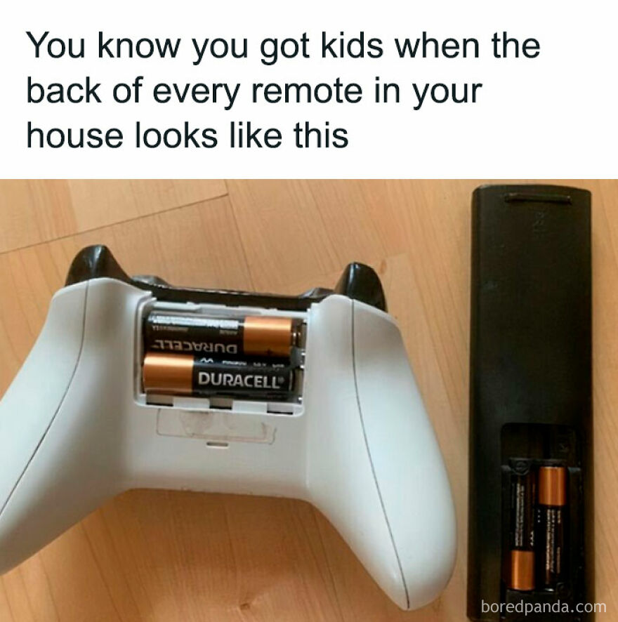 Two remotes with missing battery covers, illustrating parenthood's chaos and humor.