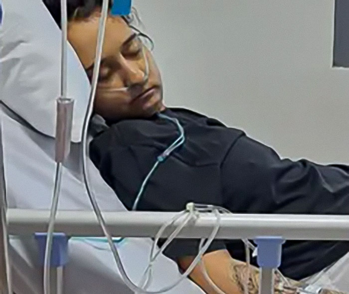 Young woman with tubes in hospital bed, related to mysterious illness during travel.