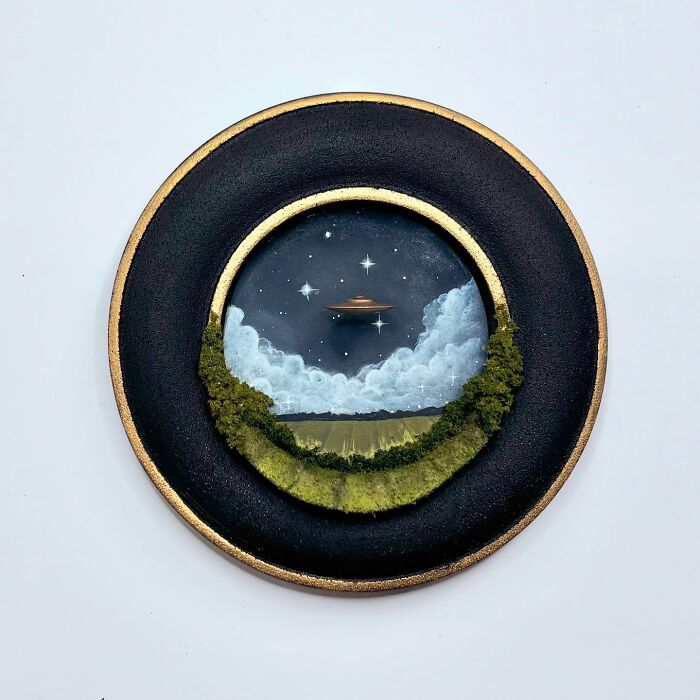 Alien-themed diorama by Caroline Dewison, featuring a UFO in a starry night sky above a lush landscape.