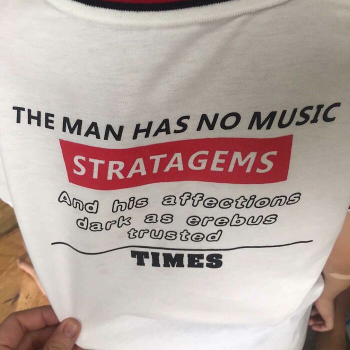 T-shirt with humorous mistranslation, featuring random phrases like "The man has no music" and "Stratagems."