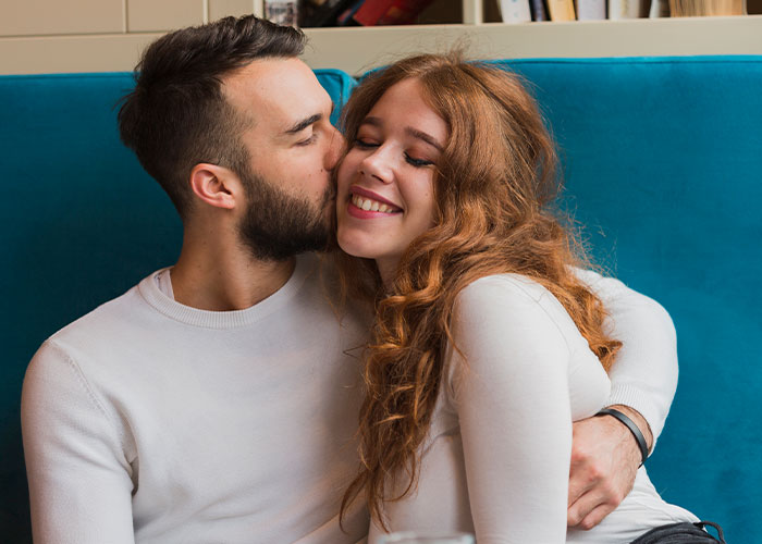 Couple sharing a tender moment on a couch, illustrating a marriage cheat code for stronger relationships.