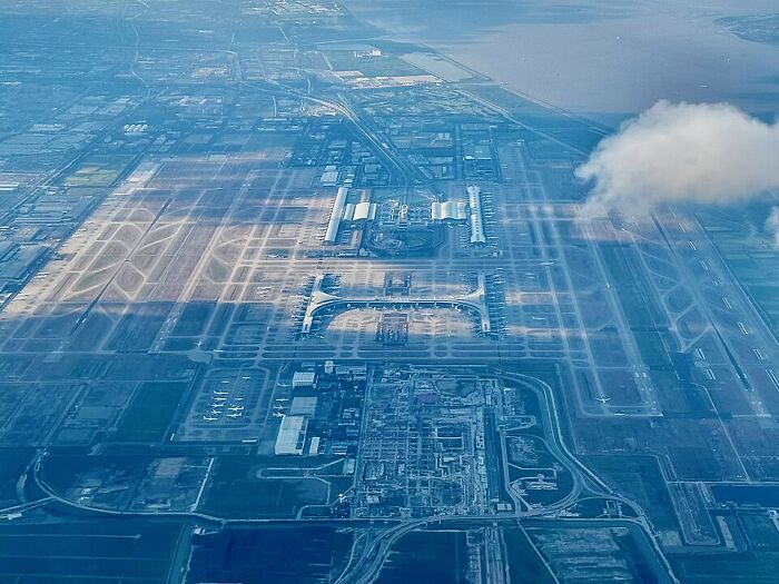 Aerial view of a busy airport, showcasing runways and terminals, highlighting the resurgence of air traffic. Aerial view of a busy airport, showcasing runways and terminals, highlighting the resurgence of air traffic.