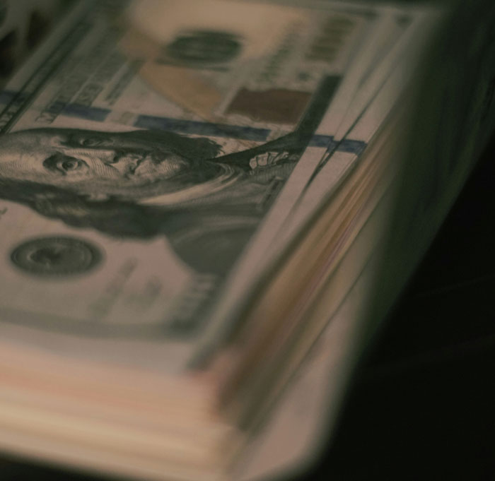 Stack of hundred-dollar bills representing wealth and success at work.