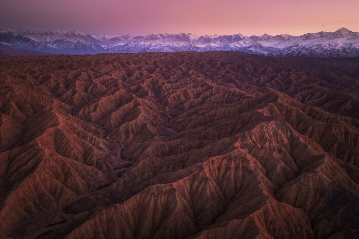 Sunset over vast, rugged mountain range, showcasing stunning nature photography.